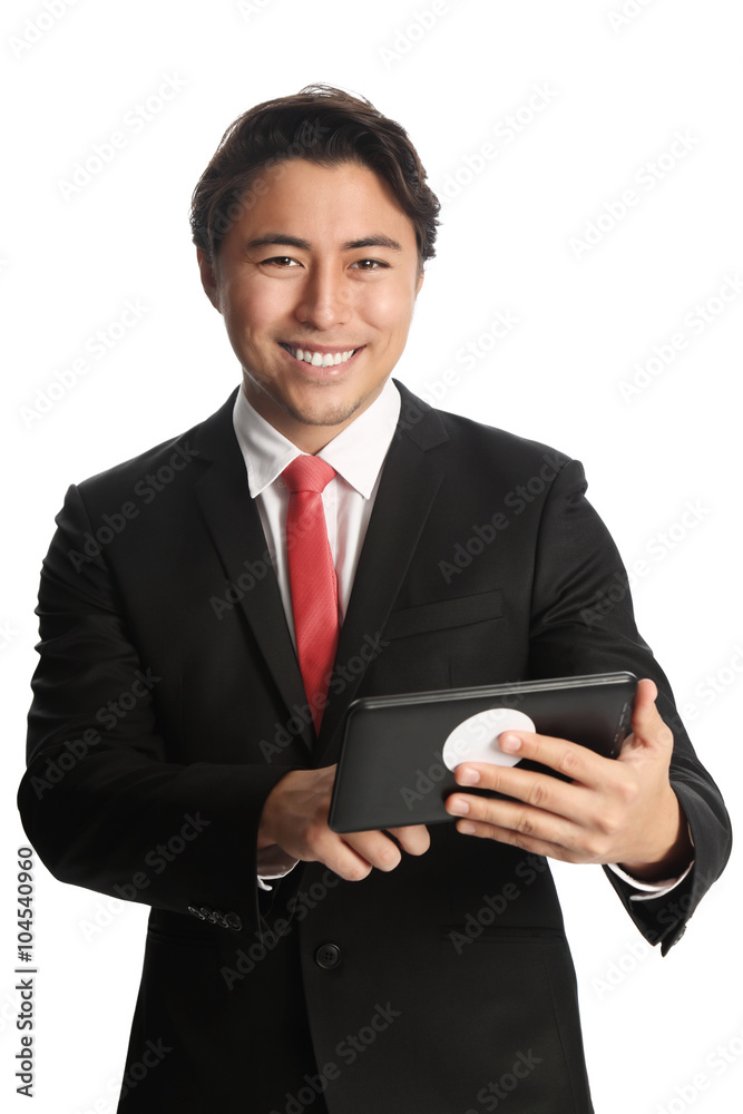 A good looking businessman wearing a black suit, white shirt and a red tie. Holding a digital reader, swiping with his finger. White background. A good looking businessman wearing a black suit, white shirt and a red tie. Holding a digital reader, swiping with his finger. White background.