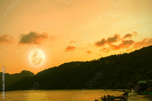 beauty nature full moon after sunset at sea mountain background