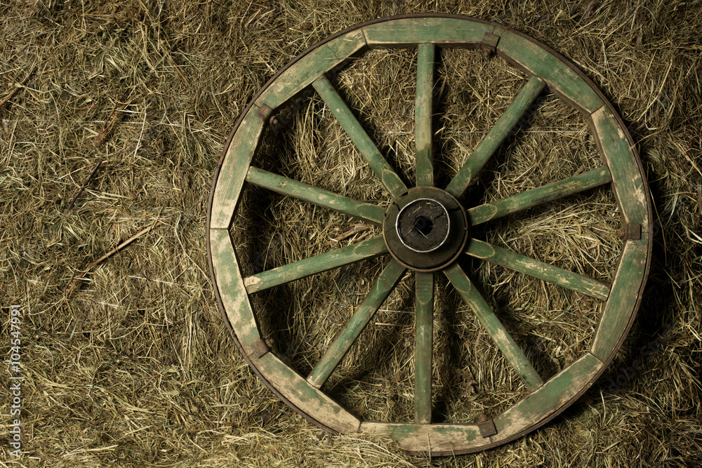 the wheel of the cart in a haystack