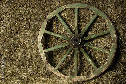 the wheel of the cart in a haystack