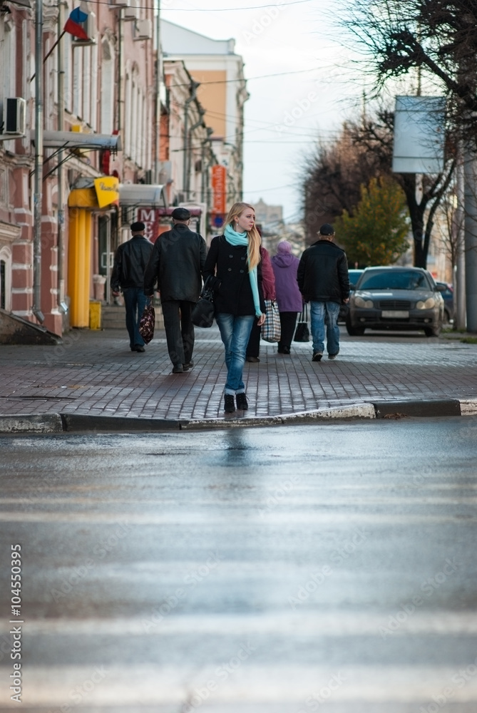 Woman about to cross the road at a pedestrian crossing Woman about to cross the road at a pedestrian crossing