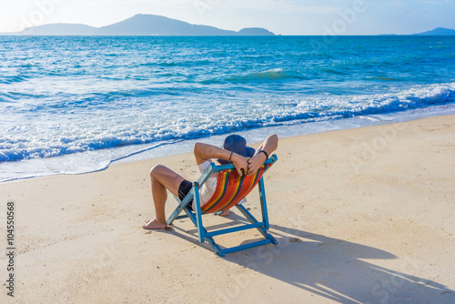 Man relaxing on beach, ocean view