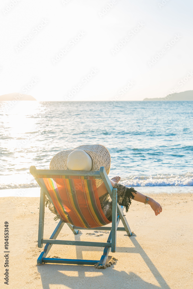 Girl on a tropical beach with hat Girl on a tropical beach with hat