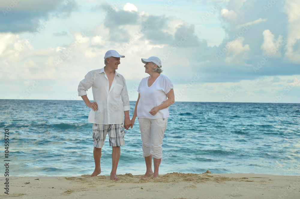 elderly couple rest at tropical resort elderly couple rest at tropical resort