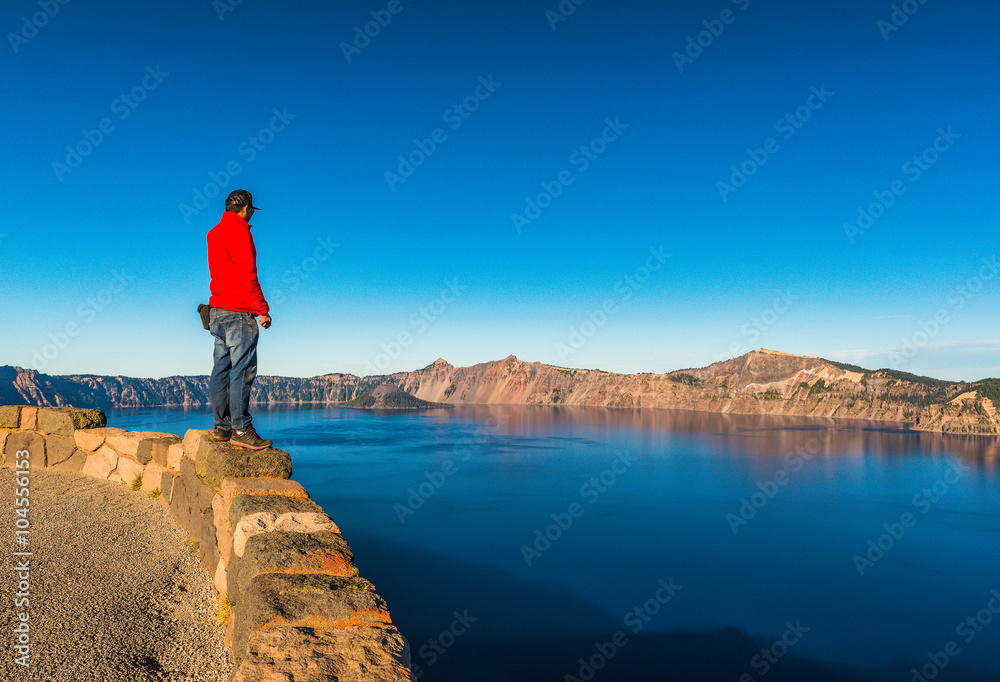 scenic view of a man stand over look to Crater lake National park ,Oregon state,usa.
