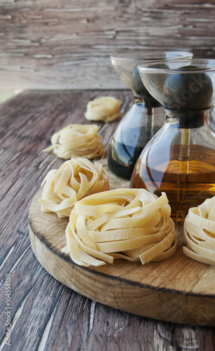 Uncooked pasta with flour on the table, selective focus