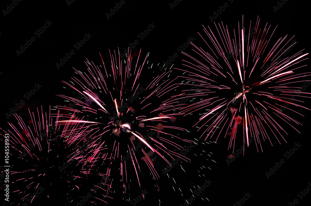 Pink fireworks display on dark sky background Pink fireworks display on dark sky background