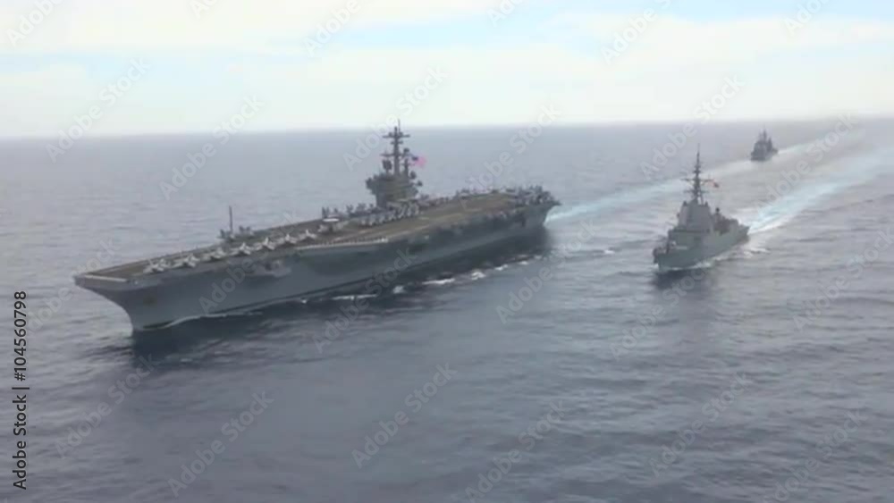 Aerial shots over aircraft carrier and other Navy craft on the sea. Aerial shots over aircraft carrier and other Navy craft on the sea.