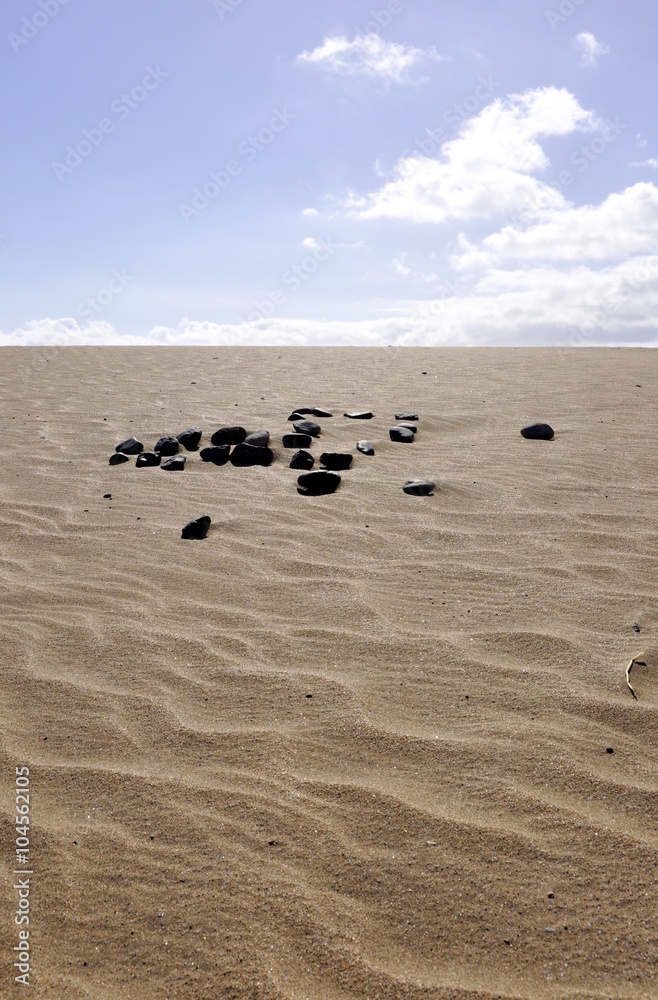 Pile of stones in a sand desert Pile of stones in a sand desert
