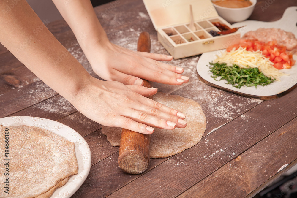 Fototapeta premium hands chef rolling pastry for tacos