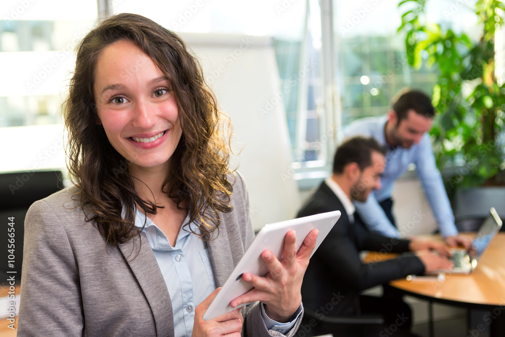 Fototapeta premium Young attractive businesswoman working at the office with associ