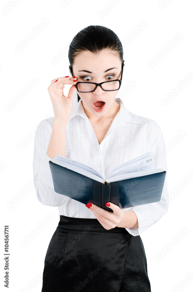 surprised, shocked businesswoman holding glasses and looking for in a notebook even more closely surprised, shocked businesswoman holding glasses and looking for in a notebook even more closely