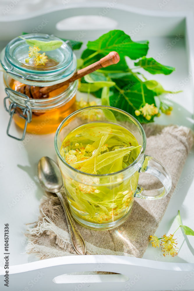 Sweet linden tea with honey in summer day Sweet linden tea with honey in summer day