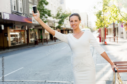 Business woman pulling suitcase bag walking in city