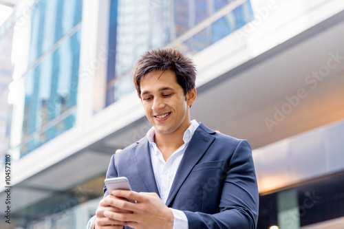 Portrait of confident businessman with mobile phone outdoors © Sergey Nivens