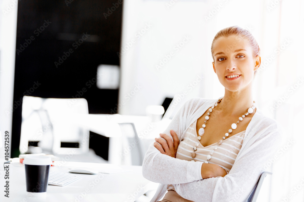 Attractive office worker sitting at desk Attractive office worker sitting at desk