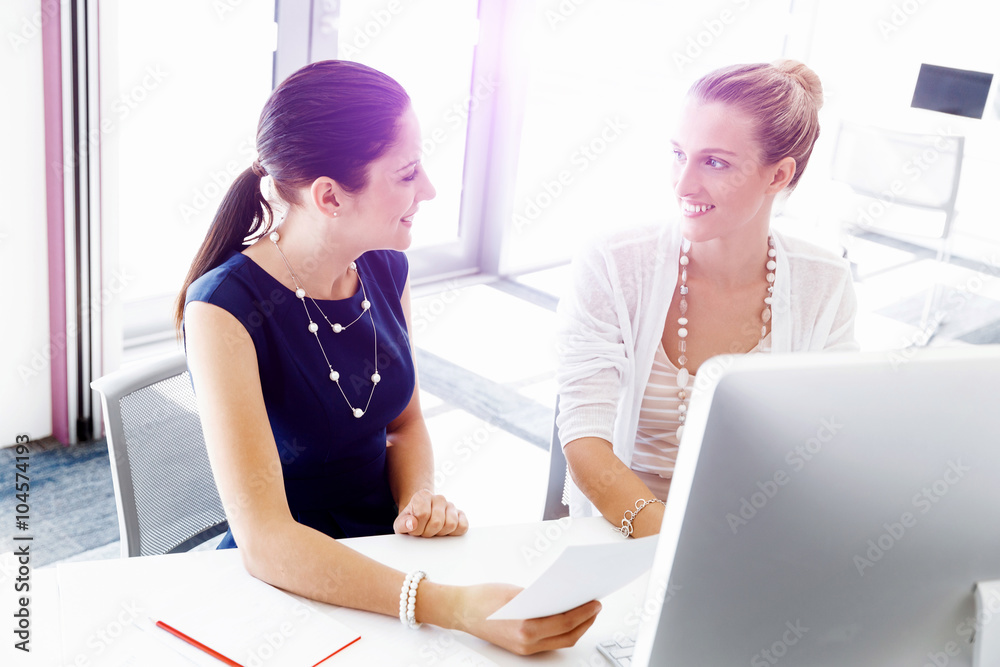 Two female colleagues in office Two female colleagues in office