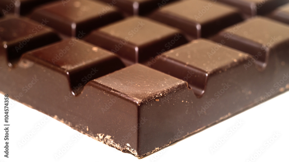 Black chocolate bar isolated on white, close-up view Black chocolate bar isolated on white, close-up view