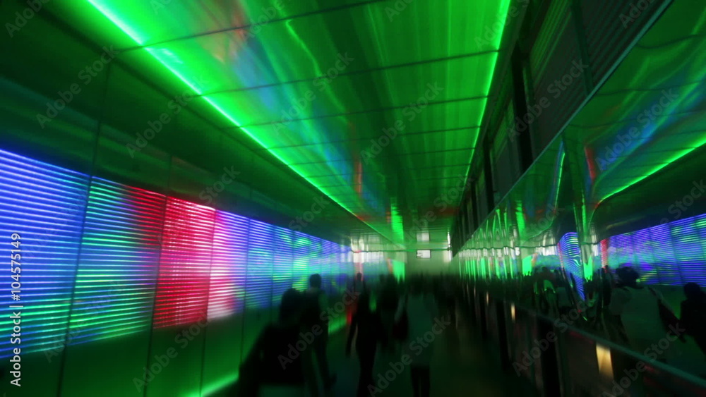 Anonymous people walking through light tunnel 01