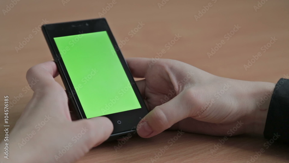 Female hands using cell phone, green screen Female hands using cell phone, green screen