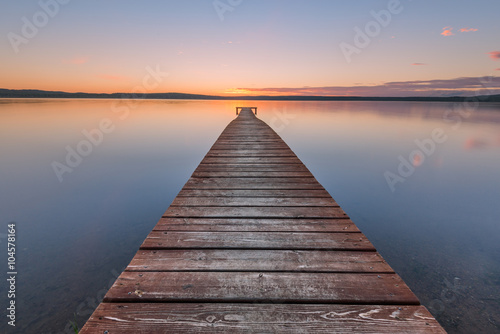 Fototapeta Naklejka Na Ścianę i Meble -  Old wooden pier on sunset
