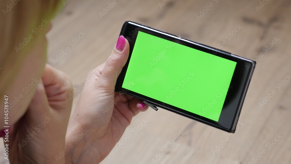 Modern woman holding green screen display mobile smart phone 4K 2160p 30fps UltraHD video - Female relaxing and looking to greenscreen mobile device 4K 3840X2160 UHD footage 
