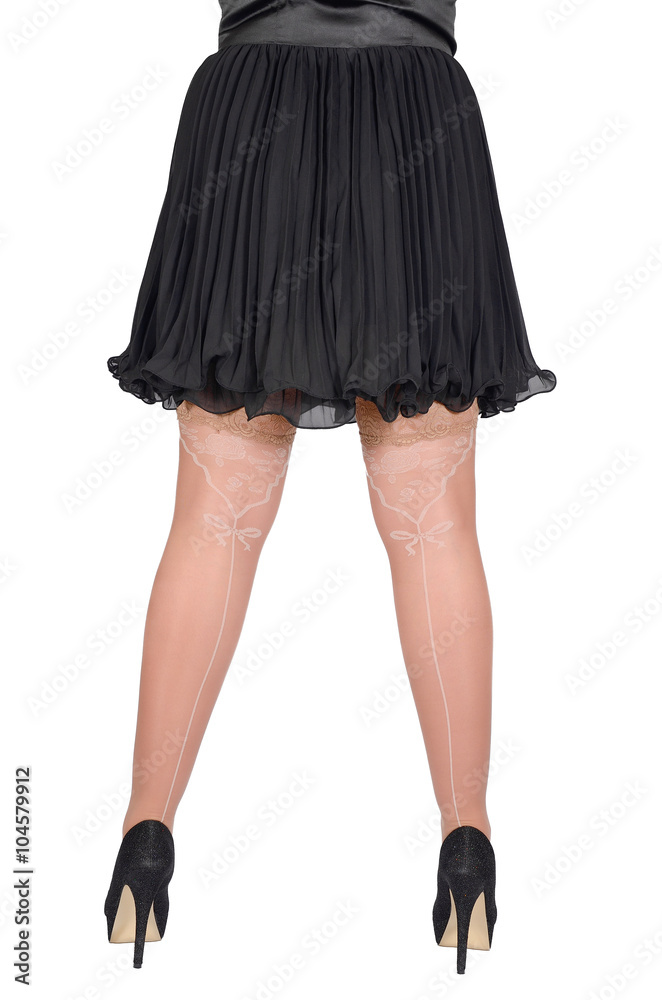 Beautiful sexy female legs in white transparent stocking and black shoes on a white background Beautiful sexy female legs in white transparent stocking and black shoes on a white background