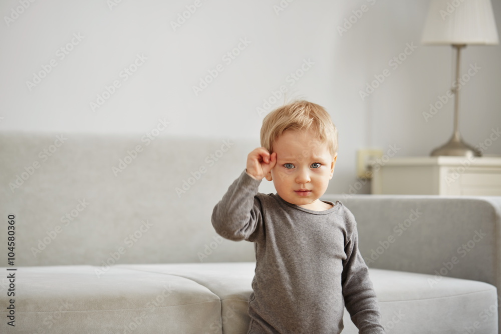Portrait of funny little boy grimacing at home