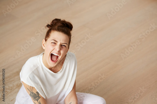 Surprise astonished woman. Closeup portrait woman looking surprised. Sitting on the floor and relaxing in the bedroom at the weekend. Positive human emotion facial expression body language. Funny girl