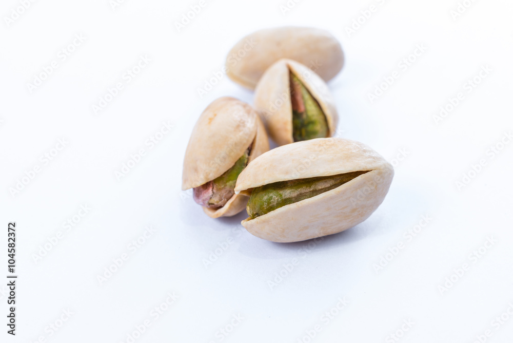 Pistachio nuts. Isolated on a white background. Pistachio nuts. Isolated on a white background.