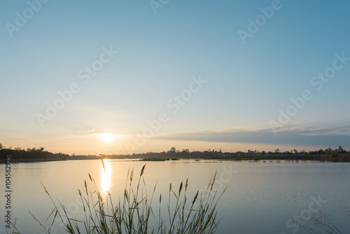 Sunset landscape over the tranquil lake