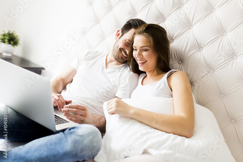 Young couple with laptop in...