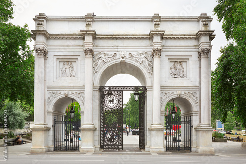 Marble Arch with green tree branches in London