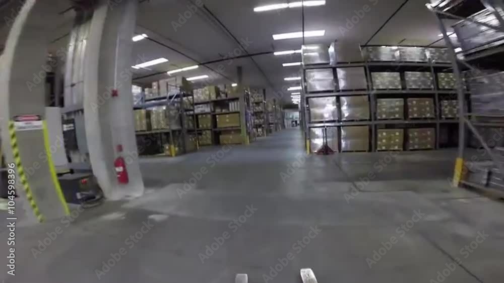High speed POV shot traveling through a large warehouse facility. High speed POV shot traveling through a large warehouse facility.