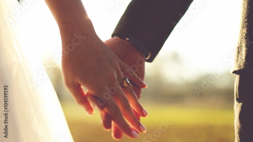 Marry Me Today And Everyday. Newlywed Couple Holding Hands, Shot In Slow Motion photo