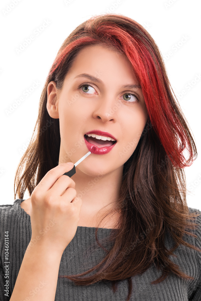 Portrait of a beautiful girl putting lip gloss Portrait of a beautiful girl putting lip gloss
