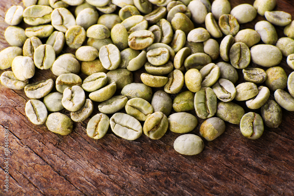 Heap of green coffee beans on table close up Heap of green coffee beans on table close up