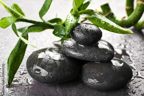 Fototapeta Naklejka Na Ścianę i Meble -  Hot spa stones with bamboo on grey background, close-up