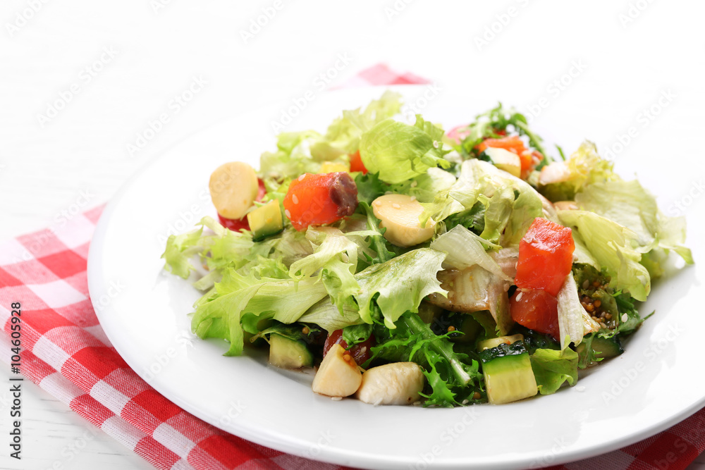 Tasty salmon salad on light wooden background