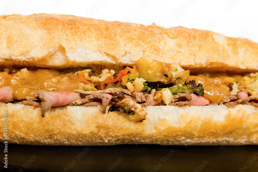 Close Up of Italian Sub Long Baguette with Ham Cheese Tomato and Close Up of Italian Sub Long Baguette with Ham Cheese Tomato and
