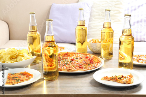 Table at home with pizza and drinks for friends