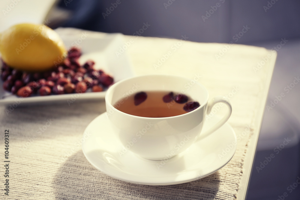 Rose hip and lemon tea on table in the room Rose hip and lemon tea on table in the room