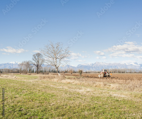 Agricultural landscape with tractor plowing.