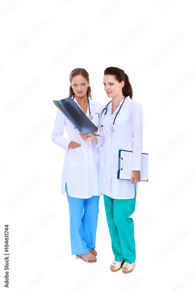 Two woman nurse watching X Ray image, standing in hospital