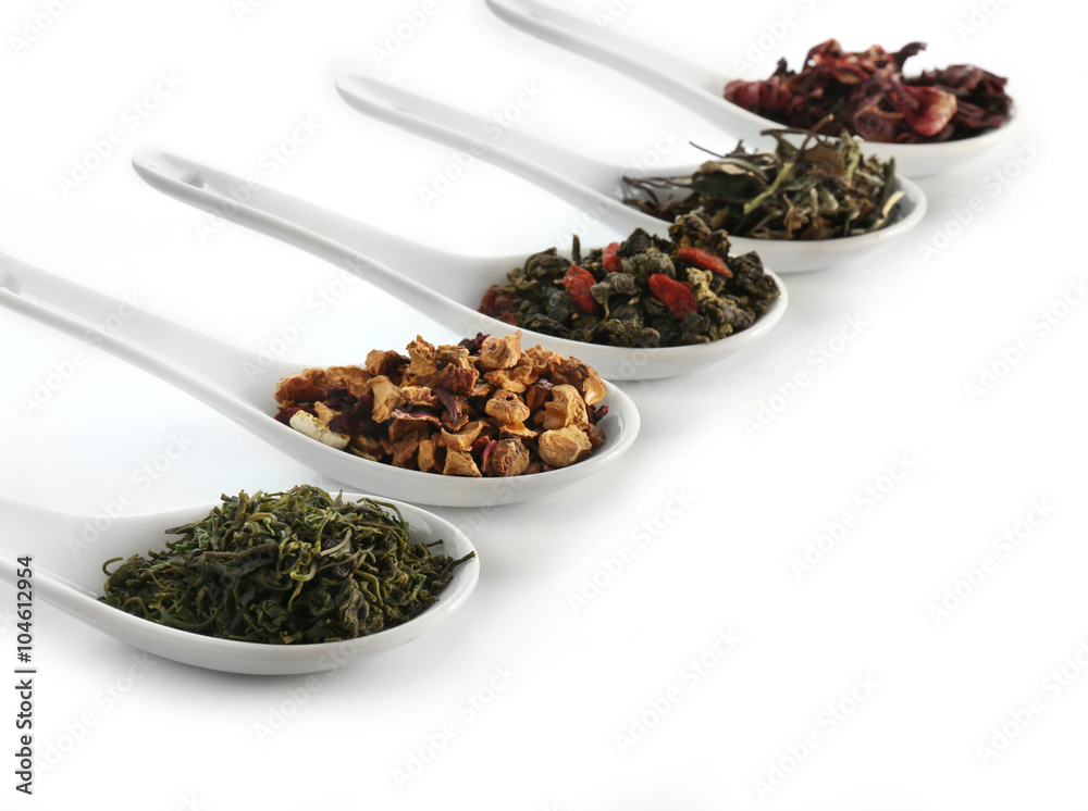 Variety of dry tea in spoons isolated on white Variety of dry tea in spoons isolated on white