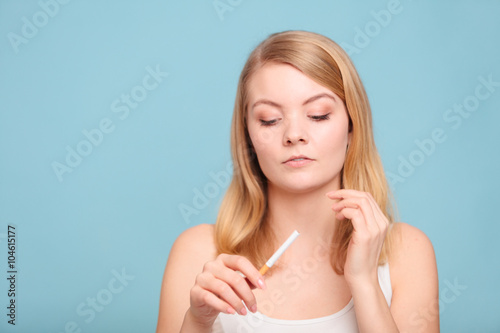 Girl with normal and electronic cigarette.