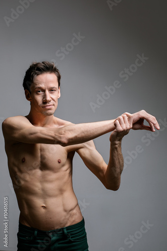 artistic portraits of young topless man on gray background