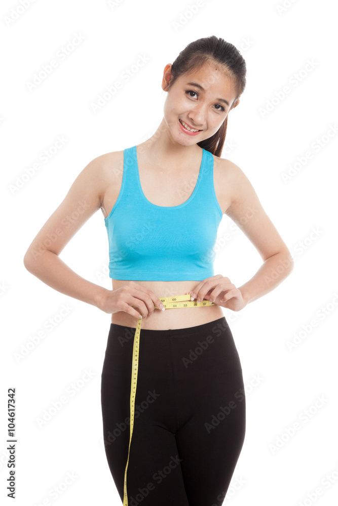 Beautiful Asian healthy girl measuring her waist