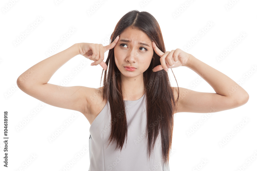 Confused young Asian woman point to her head Confused young Asian woman point to her head