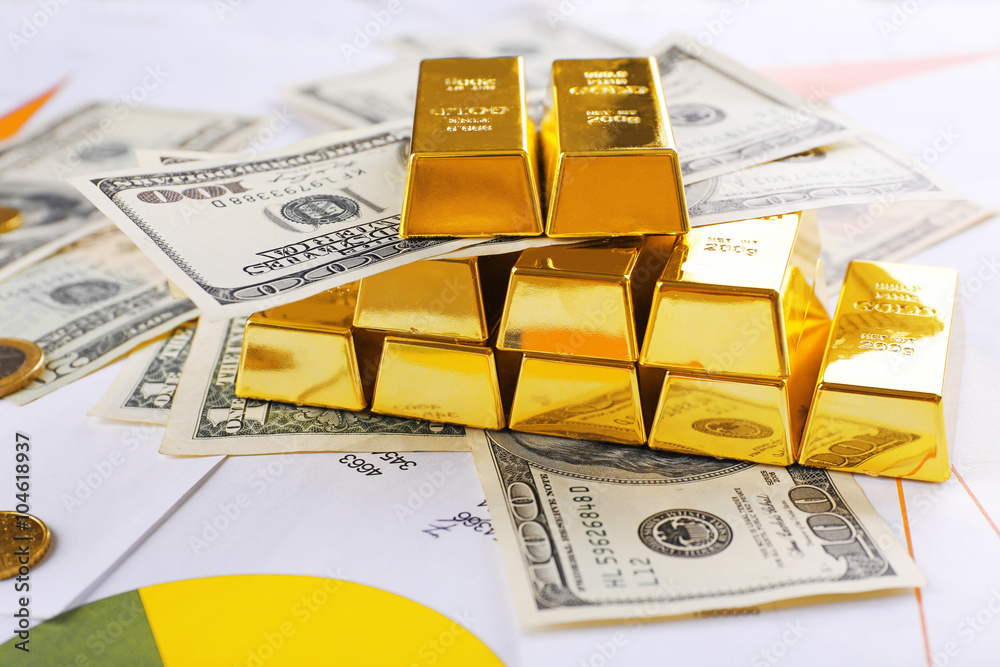 Gold bars with dollar banknotes on paper background Gold bars with dollar banknotes on paper background